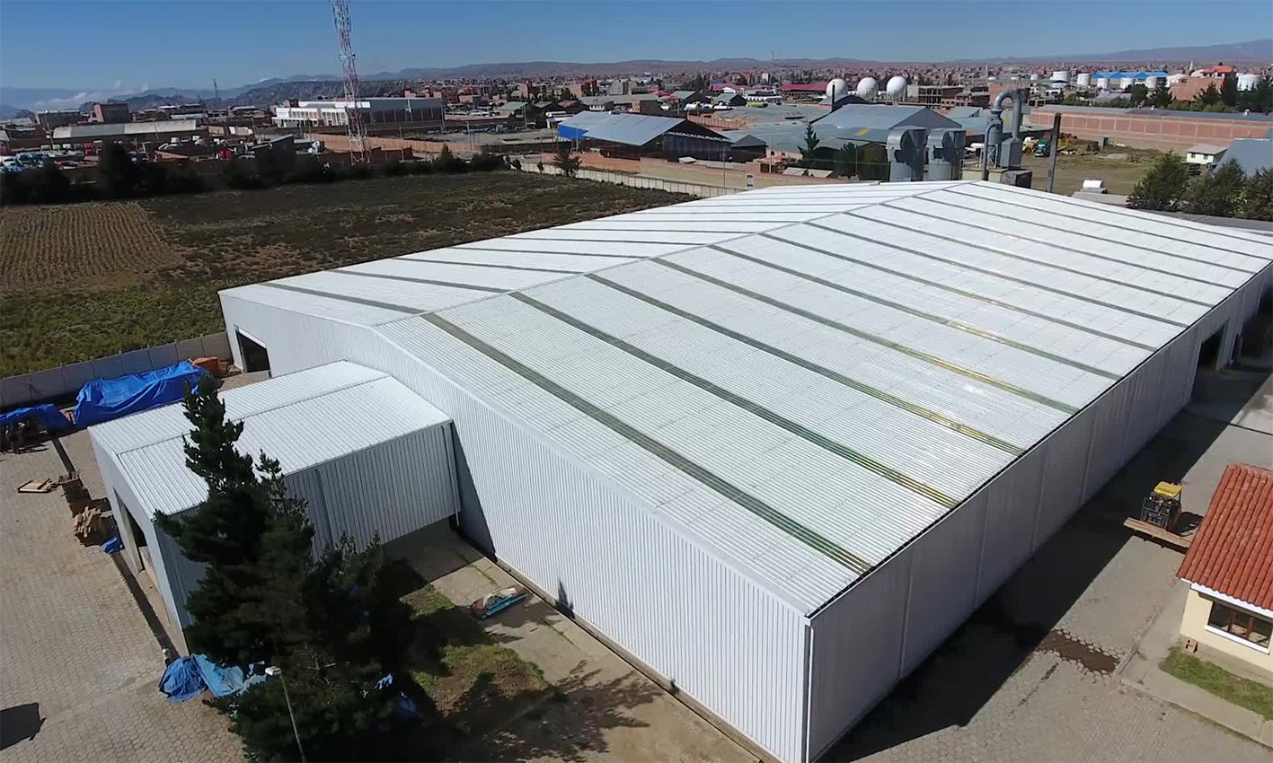 Clad steel warehouse seen from outside, with the eave line and wall sheeting visible along the elevation.