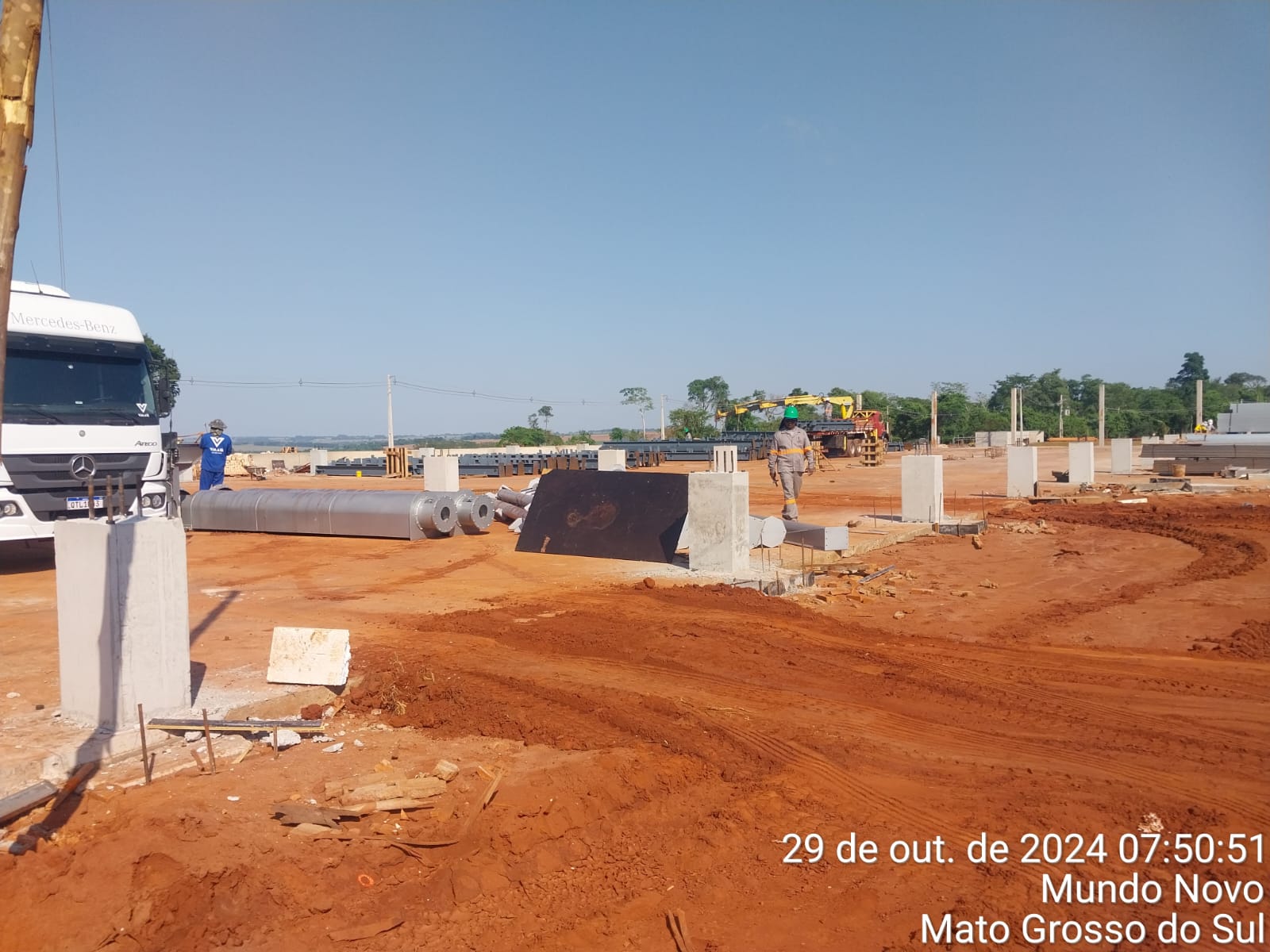 Completed steel food factory building delivered in Brazil, seen from the site access road.