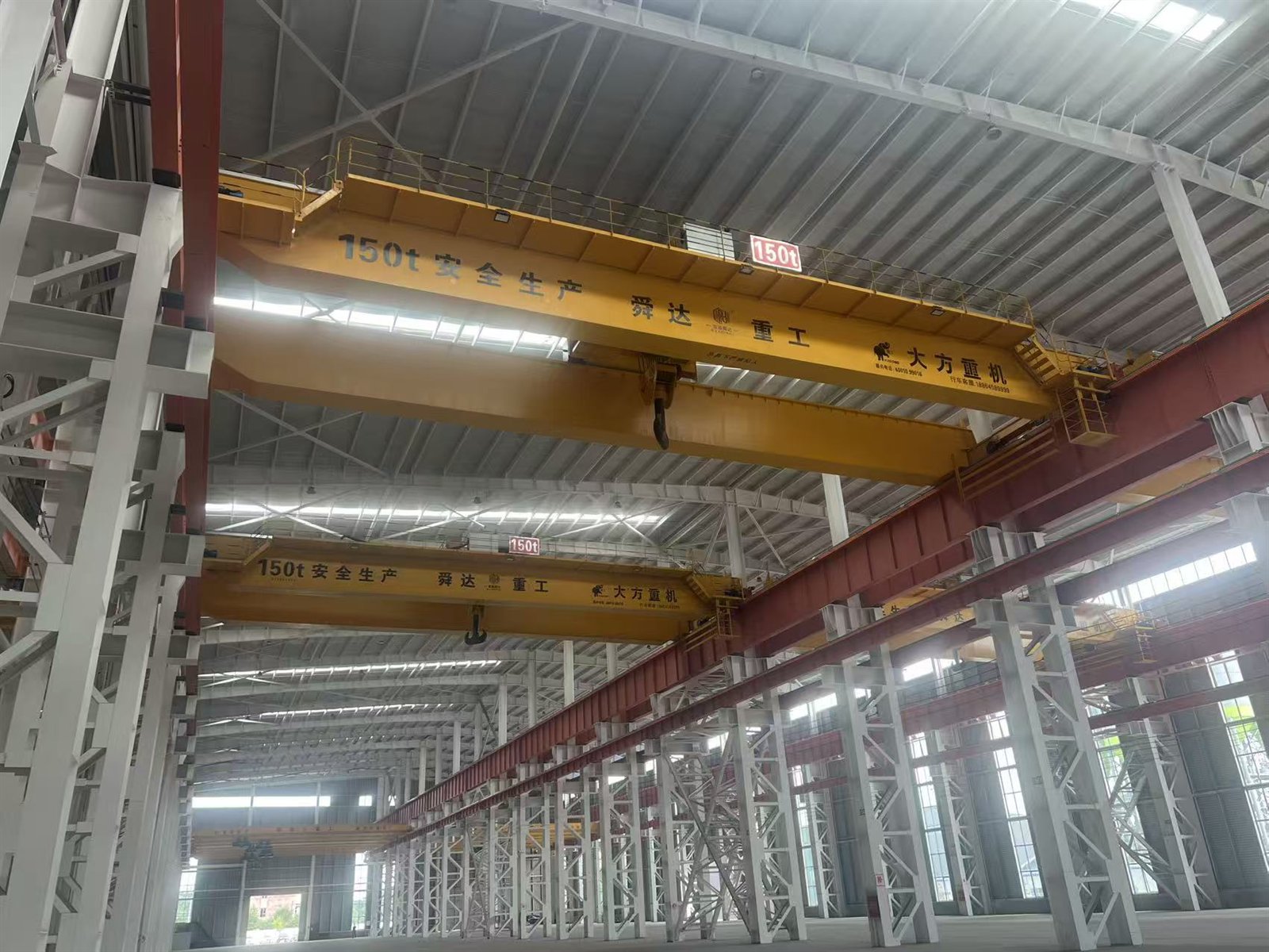 Crane runway beam fixed along a steel column line inside a fabrication workshop.